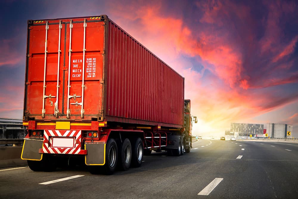 image motion blur.Truck on highway road with red container, tran