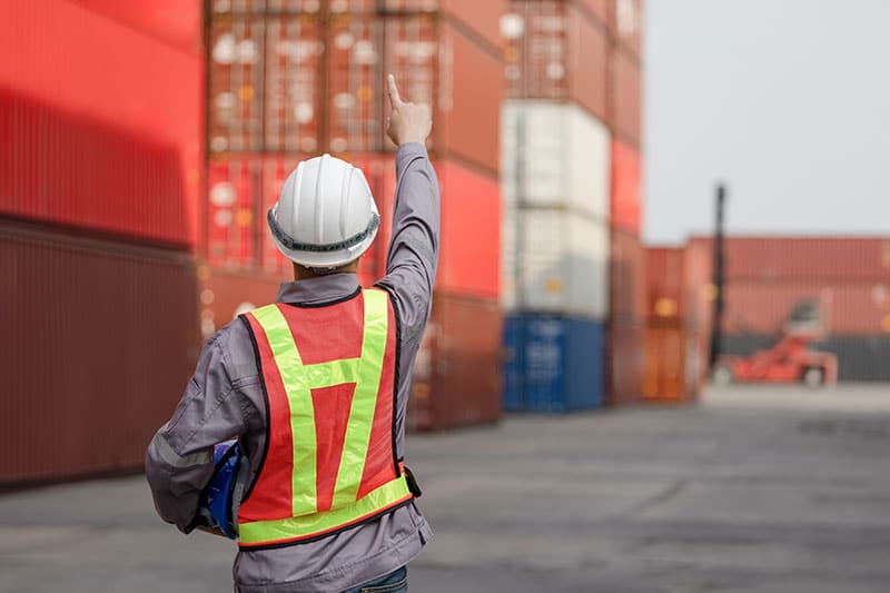 Back view of Engineer man working at industry containers cargo,